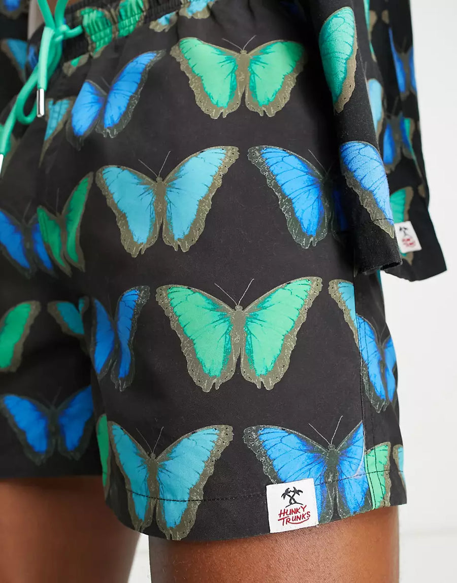 SWIM SHORTS IN BLACK AND BLUE BUTTERFLY PRINT